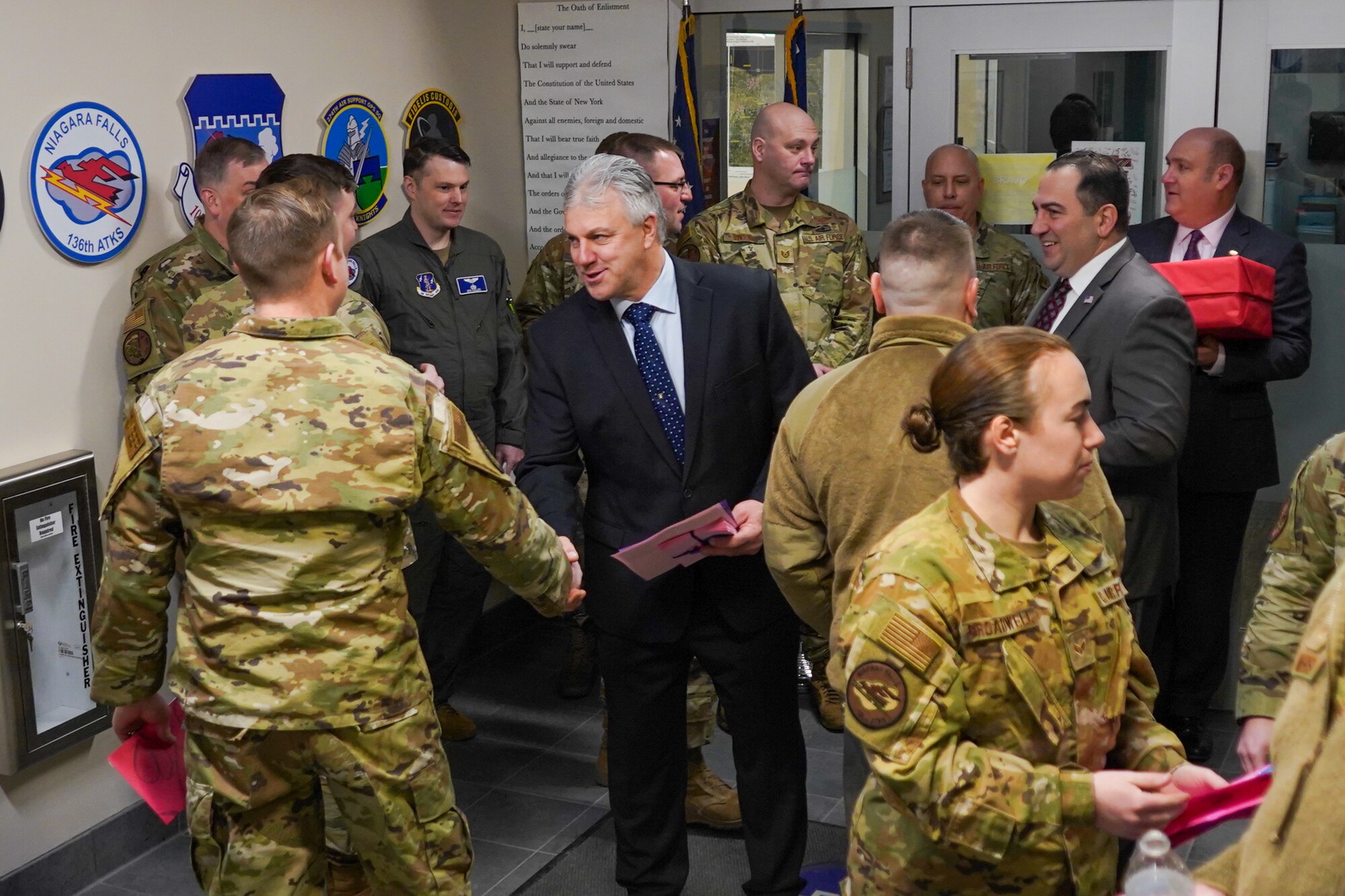 Legislature shakes hand of airman.