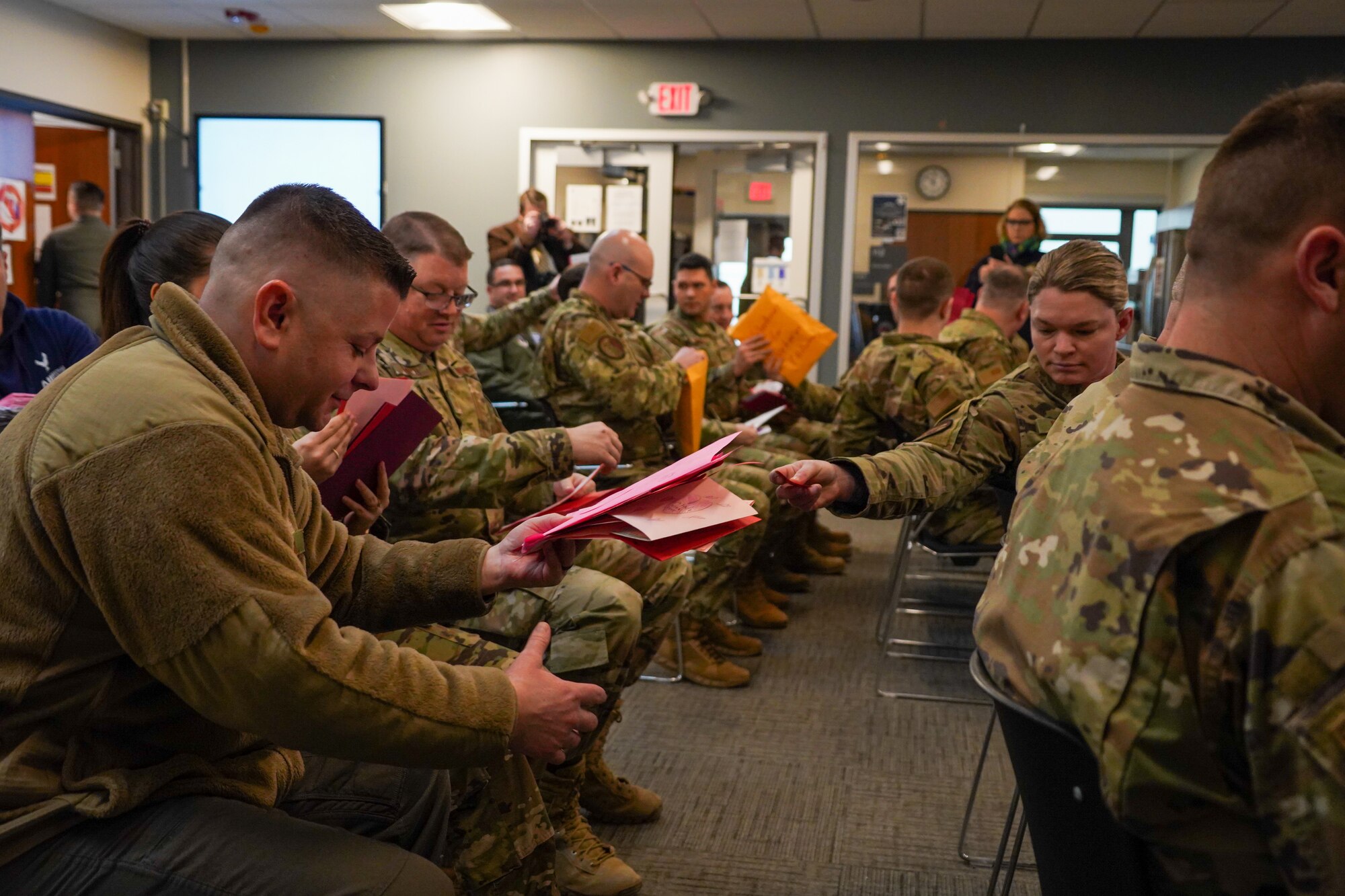 Airmen gets a Valentine's Day card handed to them.