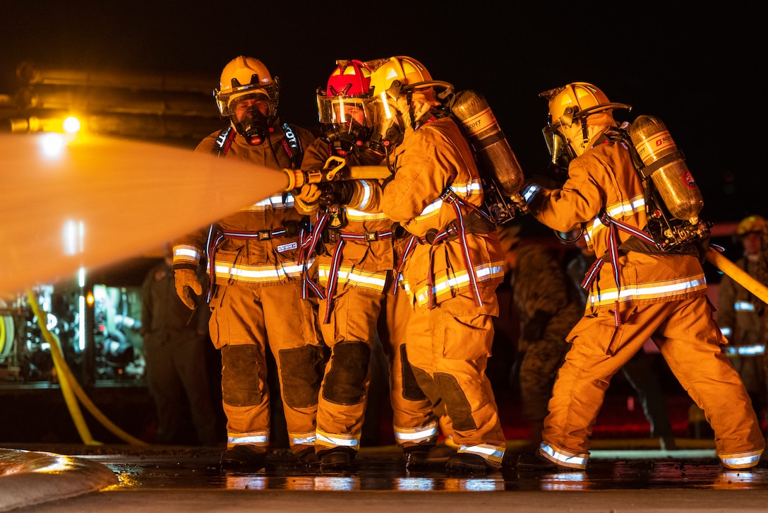 U.S. Marines with Aircraft Rescue and Firefighting practice responding to an aircraft fuel fire during an exercise on MCAS Miramar