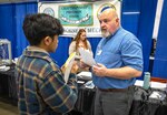 Allan Schott, hiring manager, Shop 38, Marine Machinery Mechanics, advises a job seeker Feb. 3, 2023, during the Puget Sound Naval Shipyard & Intermediate Maintenance Facility Hiring Fair. Seventeen years ago, Schott found himself in a similar position, looking for work at the shipyard. (U.S. Navy photo by Scott Hansen)