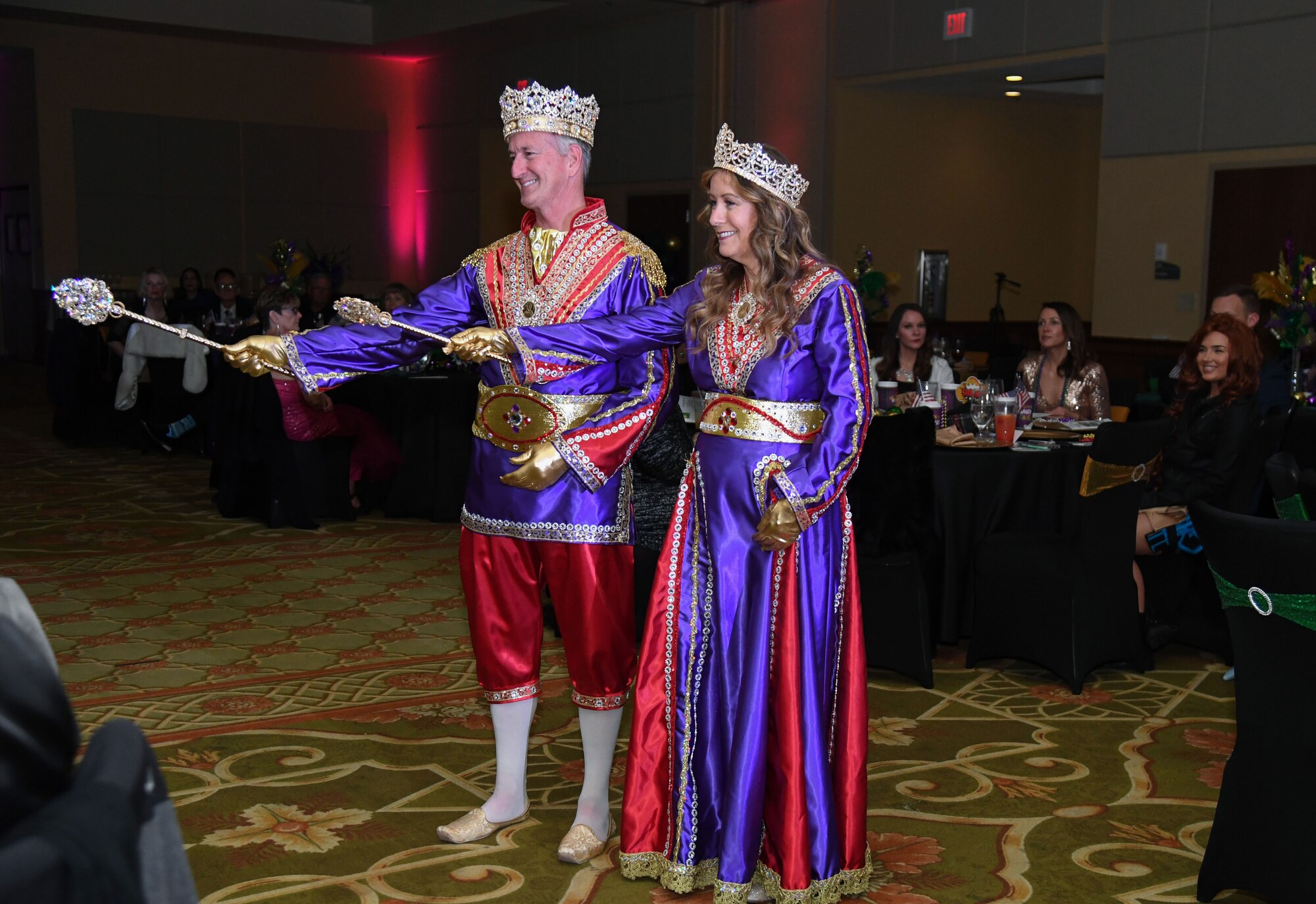 Visiting royalty from the Krewe of Gemini, Michael Schlett (King Jupiter LIII) and Sandi Schlett (Queen Leda LIII) participate in the 32nd Annual Krewe of Medics Mardi Gras Ball at the Bay Breeze Event Center on Keesler Air Force Base, Mississippi, Feb. 11, 2023.