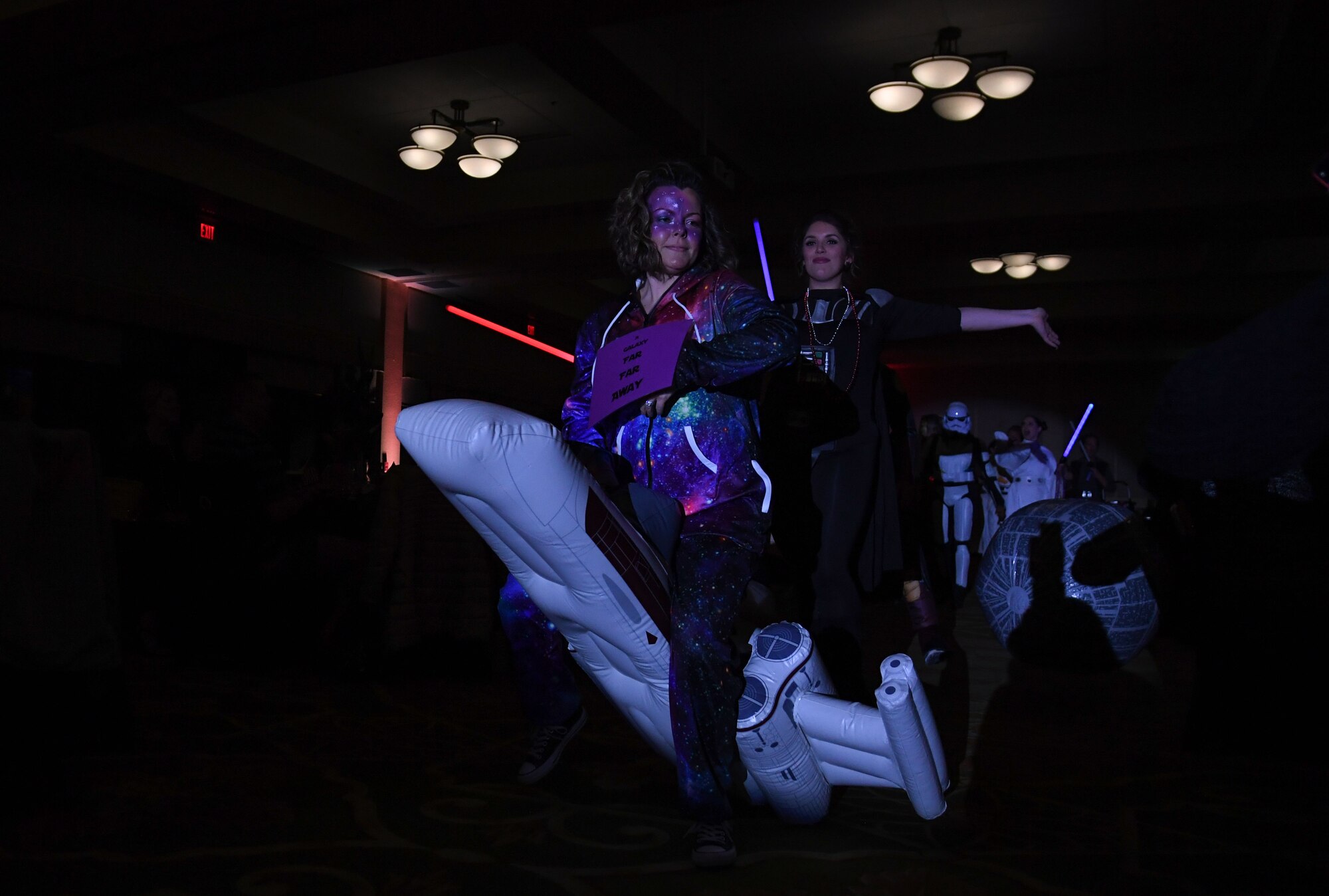 U.S. Air Force 1st Lt. Chantel Davis, 81st Inpatient Operation Squadron clinical nurse, and Lauren Edge, 81st IPTS clinical nurse, portray Star Wars characters as they make their way down the aisle during the 32nd Annual Krewe of Medics Mardi Gras Ball at the Bay Breeze Event Center on Keesler Air Force Base, Mississippi, Feb. 11, 2023.