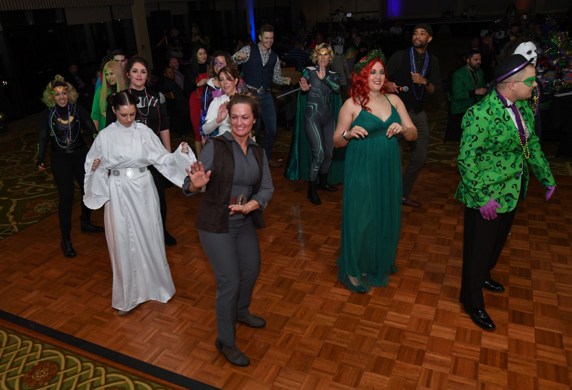 Members of the 81st Medical Group dance during the 32nd Annual Krewe of Medics Mardi Gras Ball at the Bay Breeze Event Center on Keesler Air Force Base, Mississippi, Feb. 11, 2023.
