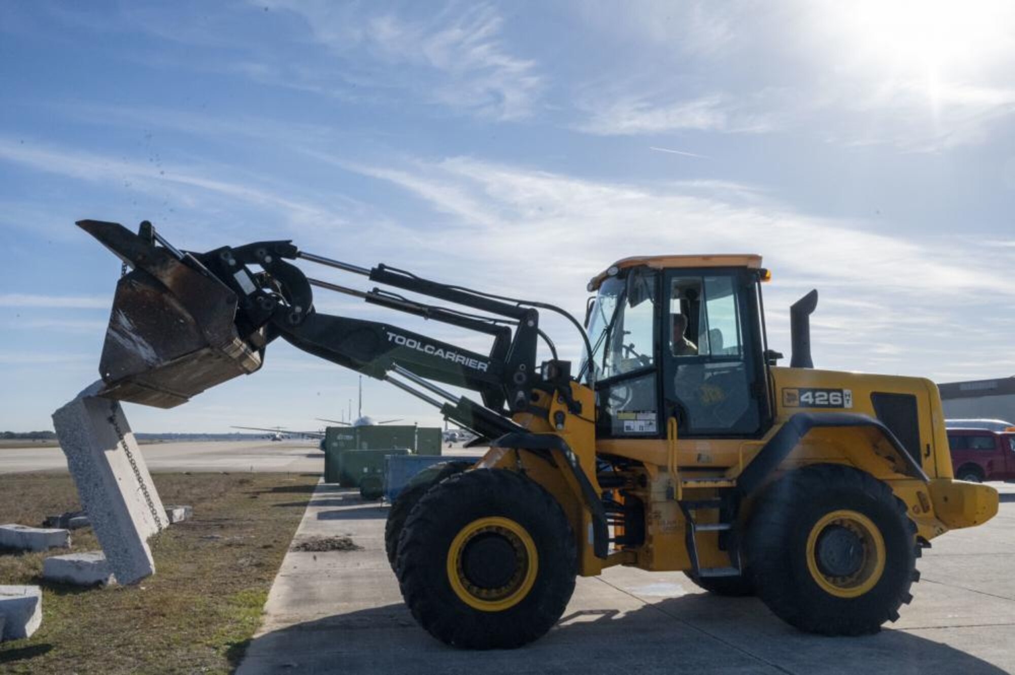 A U.S. Air Force Airman assigned to the 202nd RED HORSE Squadron, Florida Air National Guard, uses a skid-steer to remove a concrete slab from the airfield ramp at Naval Air Station Jacksonville, Florida, Feb. 7, 2023. The Airmen are rehabbing the airfield to ensure taxiway concrete can withstand the weight of the U.S. Navy's P-8A Poseidon aircraft. (U.S. Air National Guard photo by Master Sgt. Brian Cleary)