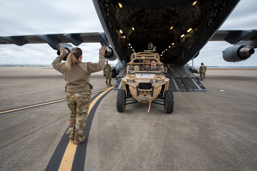 Tech. Sgt. Monica Sealey, a loadmaster with the North Carolina Air National Guard’s 156th Airlift Squadron, directs the loading of a vehicle onto a C-17 Globemaster III at the Kentucky Air National Guard Base in Louisville, Ky., Feb. 10, 2023. The vehicle is being transported to the Northern Mariana Islands for Cope North, a multinational exercise designed to enhance combat readiness in the South Pacific. Fourteen Kentucky Air Guardsmen from the 123rd Contingency Response Group are providing air base-opening and cargo-handling capabilities for Cope North. (U.S. Air National Guard photo by Phil Speck)