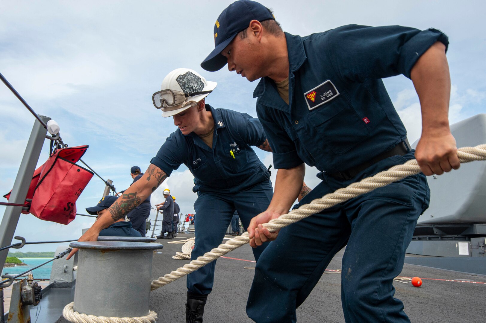 U.S. Navy Seaman Yunpeng Jiang, from Fujian, China, and Boatswain's Mate 1st Class Fawn Savoie, from Houma, La., handle mooring line during sea-and-anchor detail on the foc'scle of the Arleigh Burke-class guided-missile destroyer USS Paul Hamilton (DDG 60) during a routine port visit. Paul Hamilton, part of the Nimitz Carrier Strike Group, is in U.S. 7th Fleet conducting routine operations. 7th Fleet is the U.S. Navy’s largest forward-deployed numbered fleet, and routinely interacts and operates with Allies and partners in preserving a free and open Indo-Pacific region. (U.S. Navy photo by Mass Communication Specialist 2nd Class Elliot Schaudt)