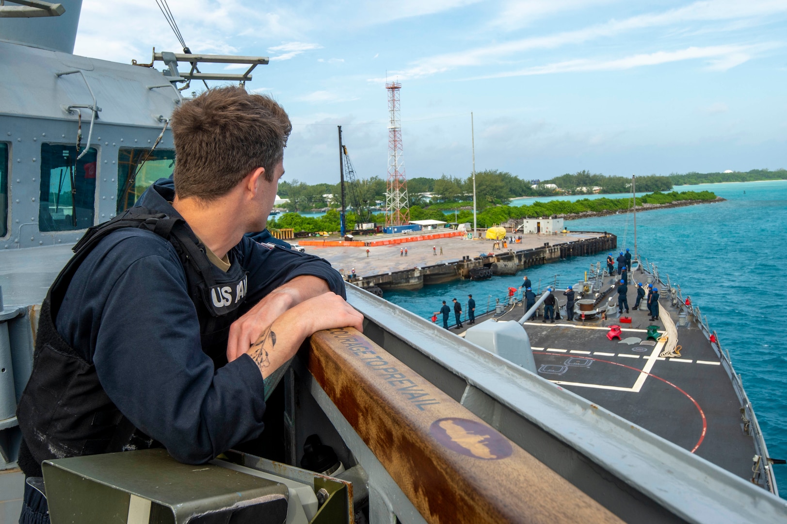 A U.S. Navy Sailor stands watch during sea-and-anchor detail on the bridgewing of the Arleigh Burke-class guided-missile destroyer USS Paul Hamilton (DDG 60) during a routine port visit. Paul Hamilton, part of the Nimitz Carrier Strike Group, is in U.S. 7th Fleet conducting routine operations. 7th Fleet is the U.S. Navy’s largest forward-deployed numbered fleet, and routinely interacts and operates with Allies and partners in preserving a free and open Indo-Pacific region. (U.S. Navy photo by Mass Communication Specialist 2nd Class Elliot Schaudt)