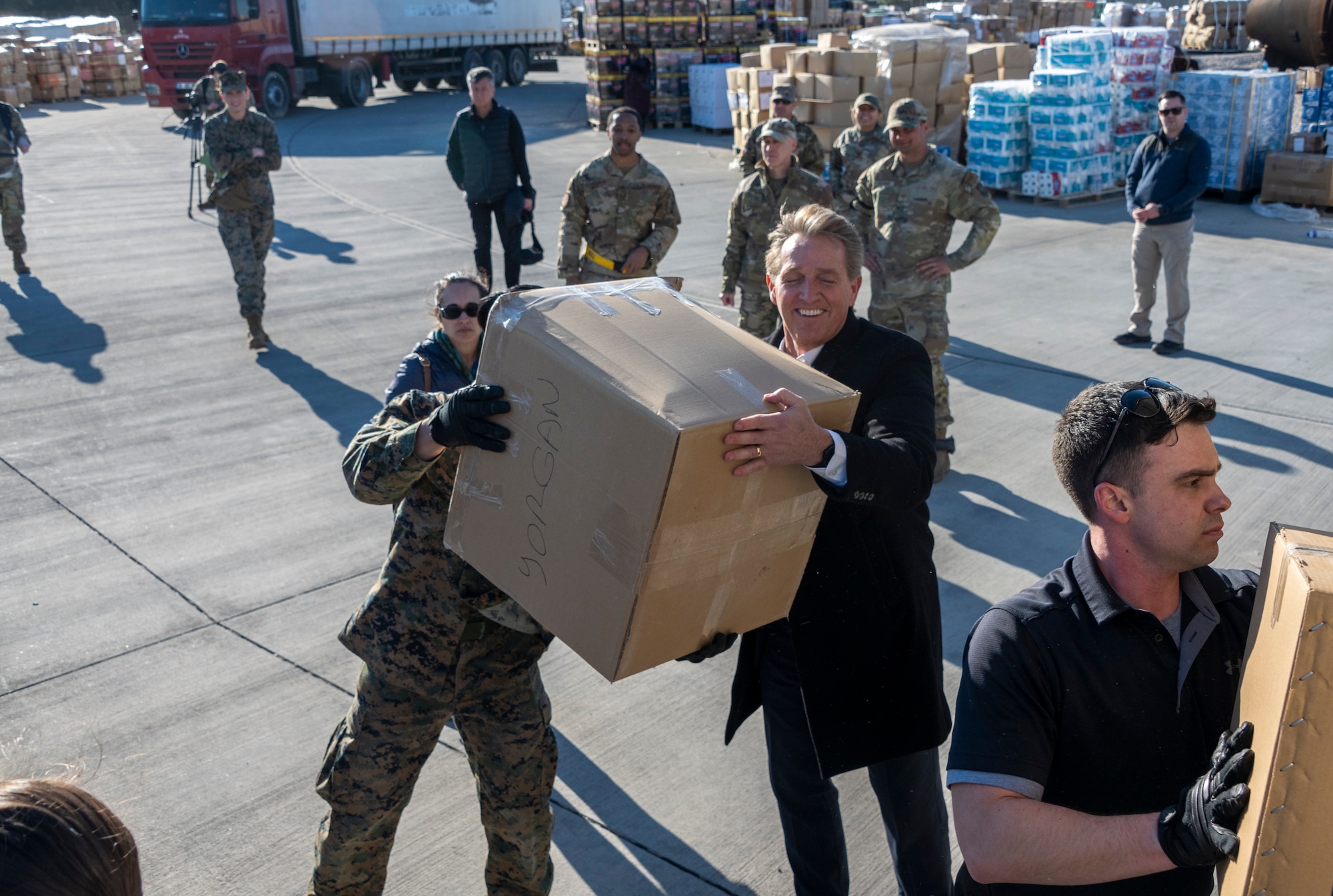 U.S. Ambassador Jeffry Flake, U.S. Ambassador to Türkiye, right, loads disaster relief supplies onto a truck with a U.S. Marine during his visit to Incirlik Air Base, Türkiye, Feb 13, 2023. Ambassador Flake visited Incirlik AB to discuss the recent earthquakes that struck central-southern Türkiye on Feb 6, 2023, and see the humanitarian support efforts first-hand. As Ambassador to Türkiye, Flake holds the highest civilian position as The Chief of Mission, and impacts the communication and resources of U.S. personnel, advancing the U.S. foreign policy goals. As a fellow NATO ally, the U.S. Government mobilized personnel to assist Türkiye in their response efforts. (U.S. Air Force photo by Senior Airman David D. McLoney)