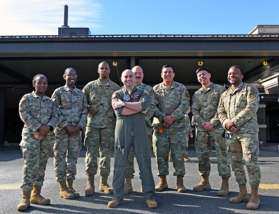 87th MDG flight surgeon poses for a picture with 87th MDG EMTs and paramedics.