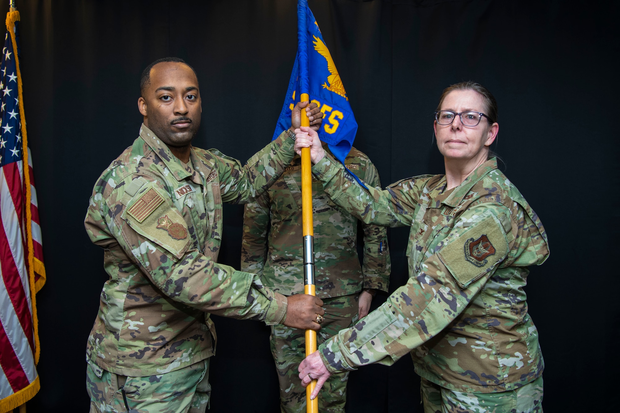 Col. Gretchen Wiltse, 434th Mission Support Group commander, passes the guidon to Capt. Chadwick Nickson during a change of commander ceremony, February 4, 2023, at Grissom Air Reserve Base, Indiana. Nickson took command of the 434th Security Forces Squadron. (U.S. Air Force photo by Staff Sgt. Alexa Culbert)