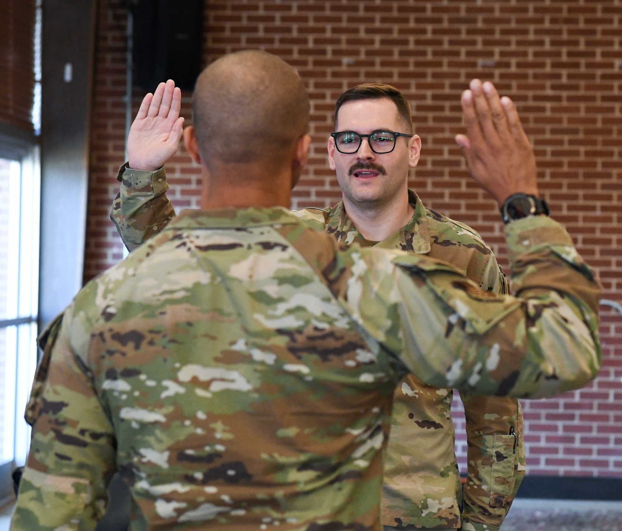 Air Force colonel administering oath of office to captain