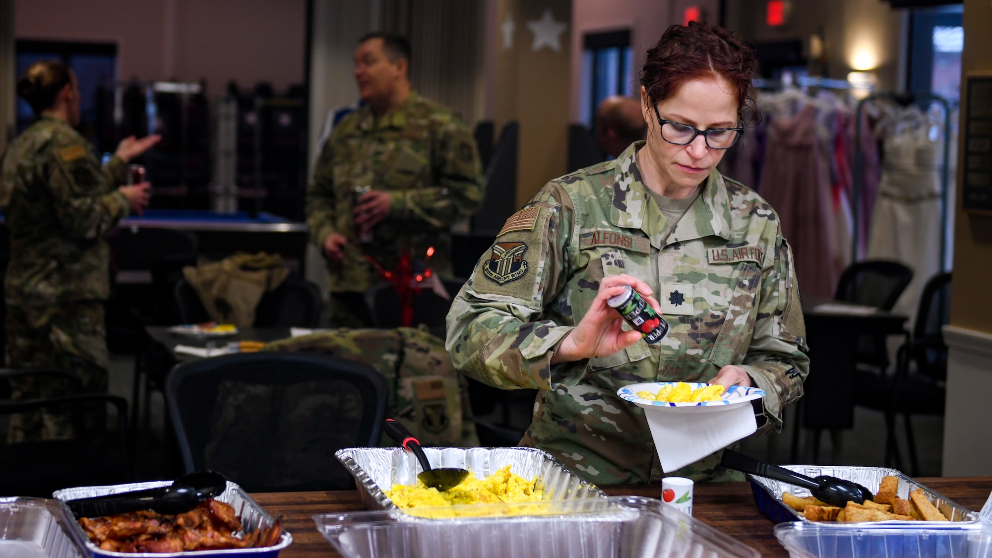 Lt. Col. Charlena Alfonsi, a nurse practitioner assigned to the 910th Medical Squadron nurse practitioner, peppers her eggs, Feb. 3, 2023, at Youngstown Air Reserve Station, Ohio.