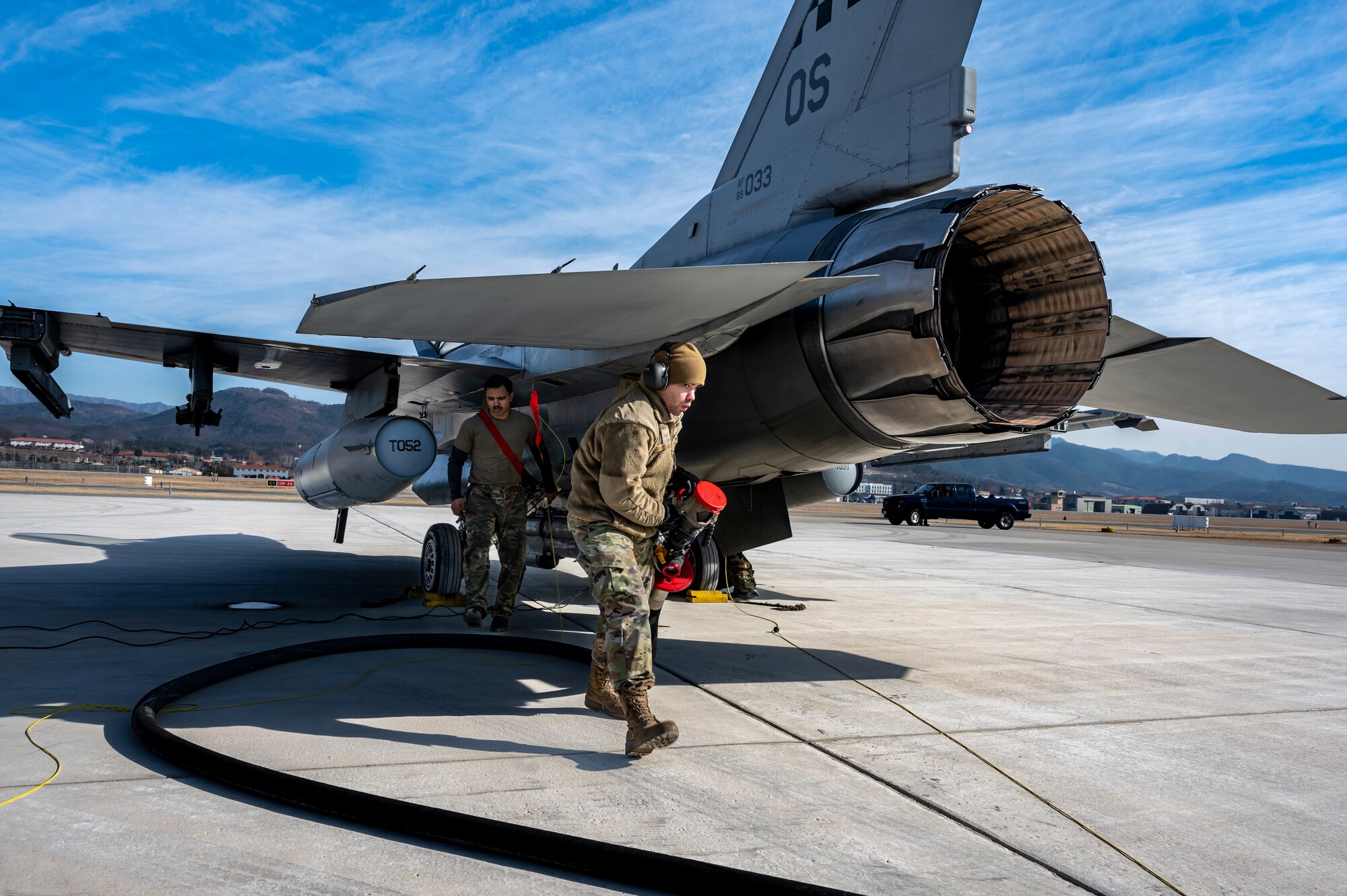 U.S. Air Force Senior Airman Brian Ramirez-Fontanez, 51st Logistics Readiness Squadron fuels service controller and Senior Airman Angel Fuentes, 36th Fighter Generation Squadron crew chief, refuel an F-16 Fighting Falcon, prior to launching at Daegu Air Base, Republic of Korea, Jan. 31, 2023.
