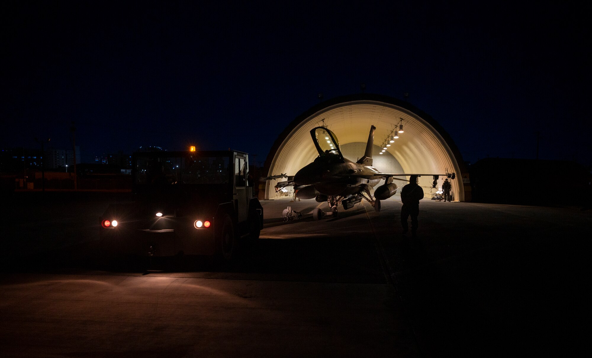 U.S. Air Force Airmen from the 51st Fighter Wing transport an F-16 Fighting Falcon to a hangar during a training event at Daegu Air Base, Republic of Korea, Feb. 1, 2023.