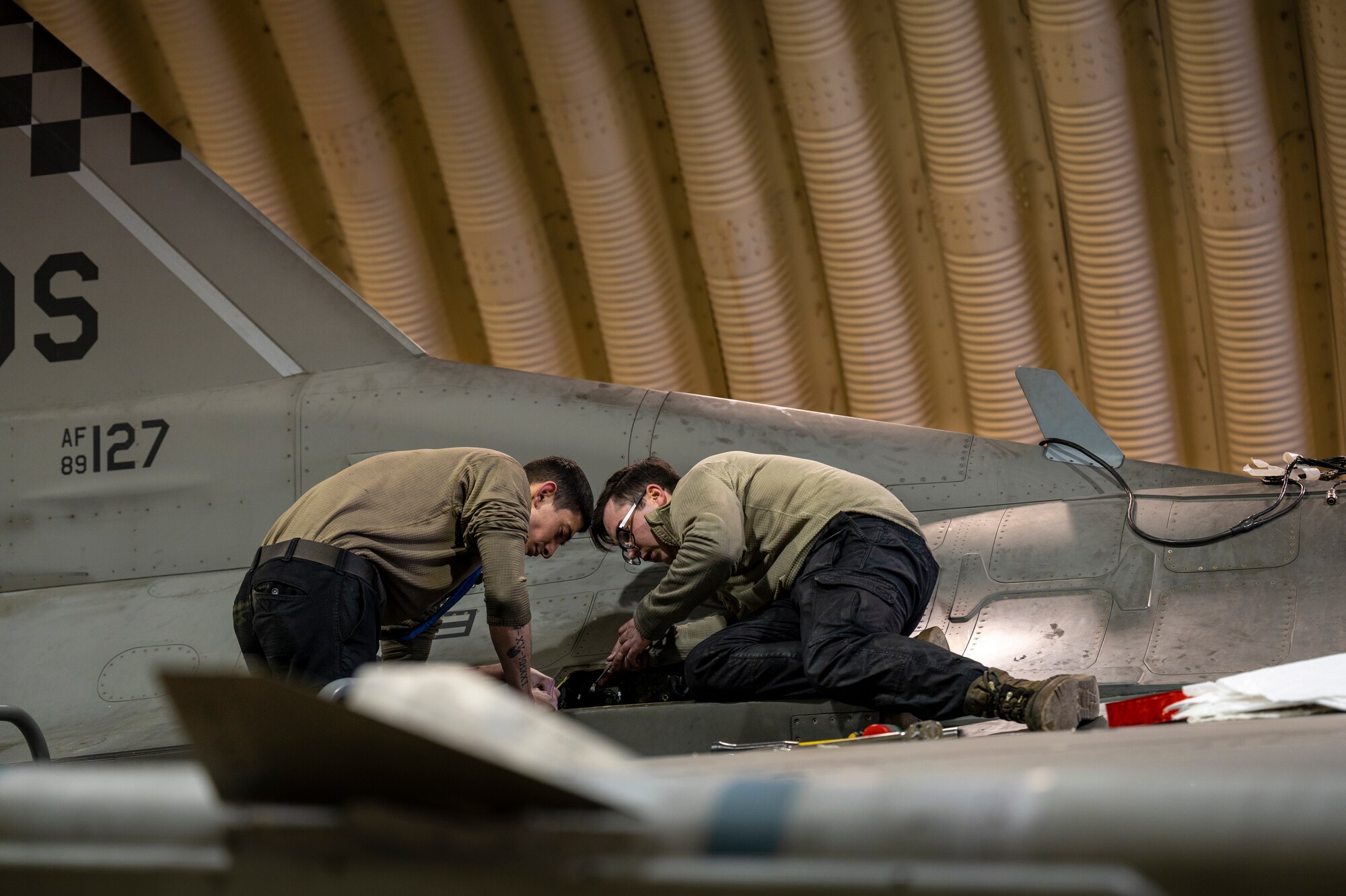 U.S. Air Force Staff Sgt. Joshua Torrez and Senior Airman Skyler Jayroe, 36th Fighter Generation Squadron crew chiefs, perform post-flight maintenance on an F-16 Fighting Falcon during a training event at Daegu Air Base, Republic of Korea, Feb. 2, 2023.