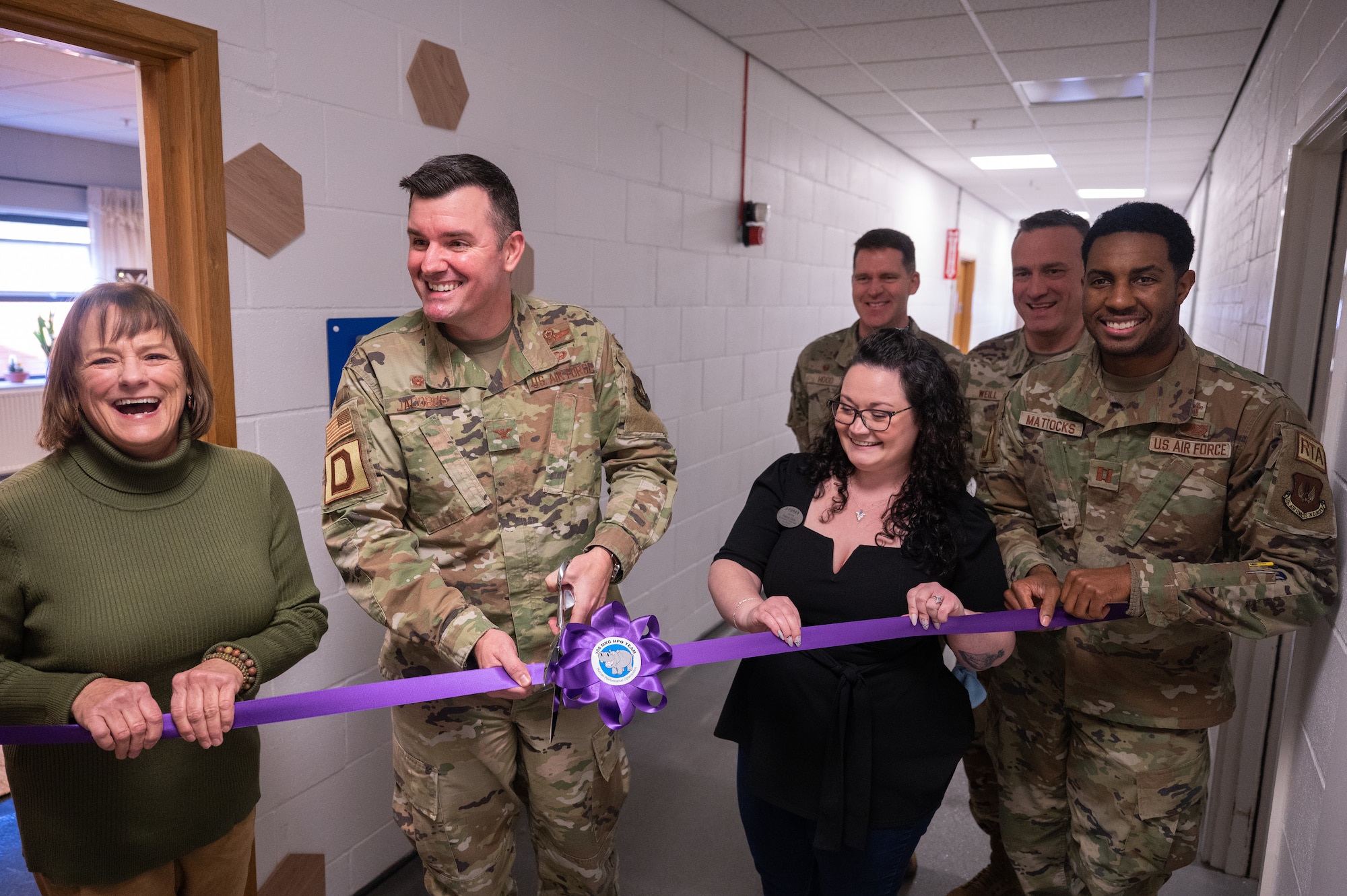 U.S. Air Force Col. Gene Jacobus, 100th Air Refueling Wing commander, cuts the ribbon to the newly added Human Performance Optimization room, Feb. 8, 2023, at Royal Air Force Mildenhall, England.