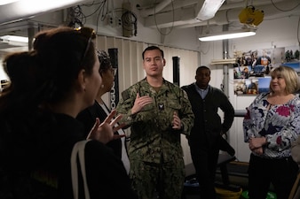 Hospital Corpsman Second Class Noah Lopez, from Escondido, Calif., presents medical department onboard the Nimitz-class aircraft carrier USS Abraham Lincoln (CVN 72) to Navy Office of Legislative Affairs (OLA) liaisons. Navy OLA’s caseworker workshops help congressional caseworkers gain a greater understanding of Navy facilities, operations, and perspectives, and provide caseworkers the opportunity to tour ships, squadrons, or facilities; meet Sailors and leadership; and discuss various topics that affect constituent casework. (U.S. Navy photo by Mass Communications Specialist 3rd Class Jacqueline Orender)