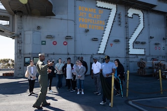 Lt. Brandon Russel, from Stockbridge, Ga., gives a tour for representatives from the Navy Office of Legislative Affairs (OLA) liaisons on the flight deck of the Nimitz-class aircraft carrier USS Abraham Lincoln (CVN 72). Navy OLA’s caseworker workshops help congressional caseworkers gain a greater understanding of Navy facilities, operations, and perspectives, and provide caseworkers the opportunity to tour ships, squadrons, or facilities; meet Sailors and leadership; and discuss various topics that affect constituent casework. (U.S. Navy photo by Mass Communications Specialist 3rd Class Jacqueline Orender)