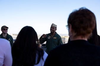 Lt. Brandon Russel, from Stockbridge, Ga., gives a tour for representatives from the Navy Office of Legislative Affairs (OLA) liaisons on the flight deck of the Nimitz-class aircraft carrier USS Abraham Lincoln (CVN 72). Navy OLA’s caseworker workshops help congressional caseworkers gain a greater understanding of Navy facilities, operations, and perspectives, and provide caseworkers the opportunity to tour ships, squadrons, or facilities; meet Sailors and leadership; and discuss various topics that affect constituent casework. (U.S. Navy photo by Mass Communication Specialist 3rd Class Han Puyu)