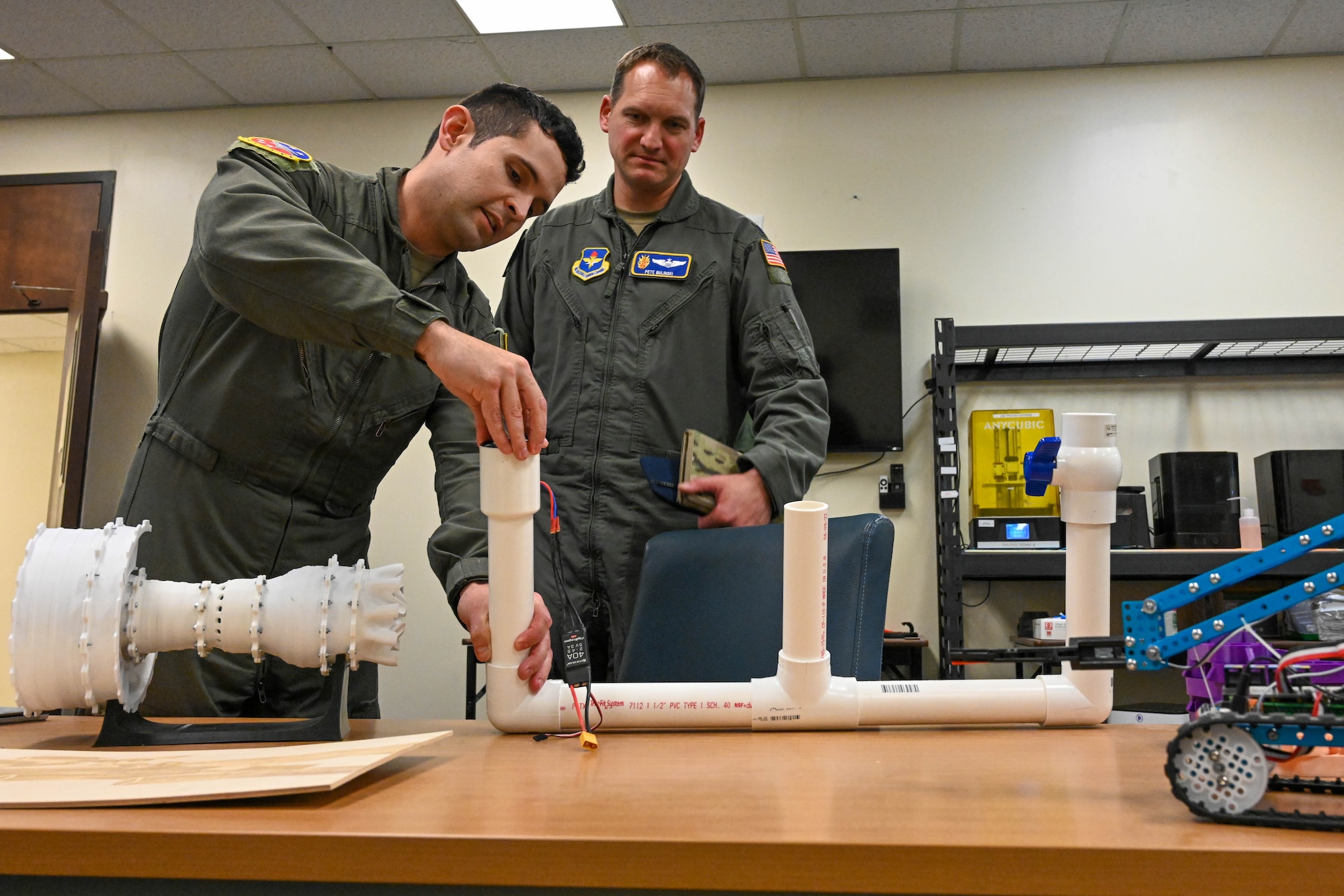 U.S. Air Force Capt. Mark Richardson, 54th Air Refueling Squadron instructor pilot, showcases some of his innovations to Lt. Col. Peter Bulinski, 97th Air Mobility Wing Innovation Center director, at Altus Air Force Base (AFB), Oklahoma, Feb. 13, 2023. Richardson developed these ideas at his previous base’s Spark Cell and brought them with him to Altus AFB to share. (U.S. Air Force photo by Senior Airman Trenton Jancze)