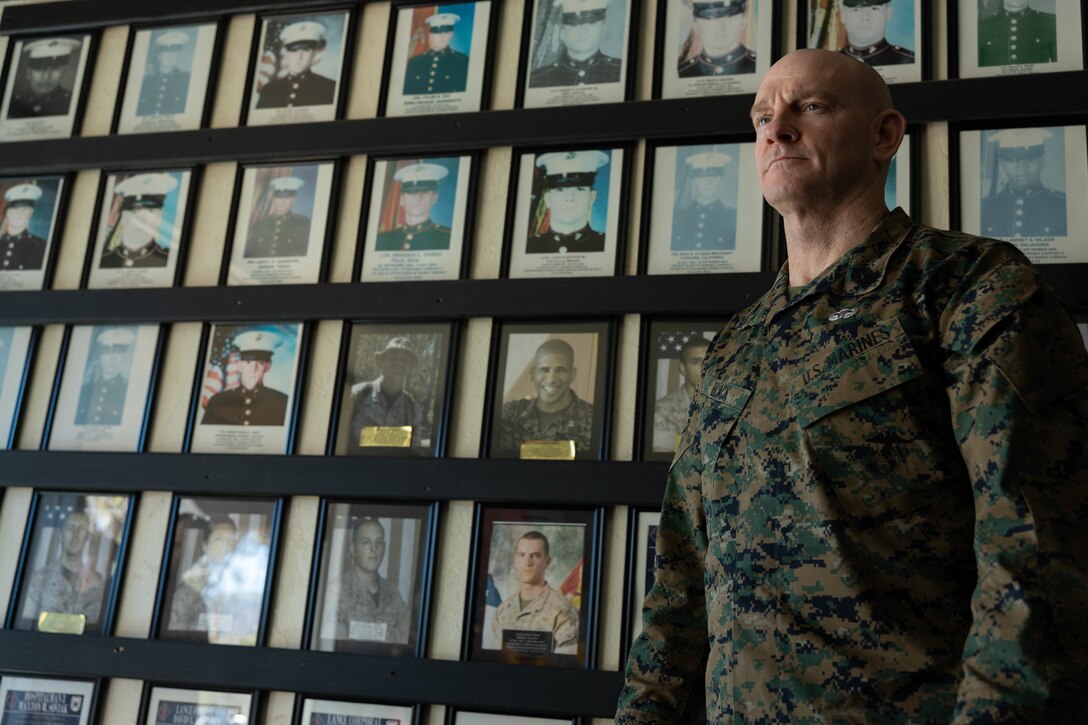 U.S. Marine Corps Sgt. Maj. Troy E. Black, the 19th Sergeant Major of the Marine Corps, poses for a photo next to a memorial wall at the headquarters of 1st Marine Regiment, 1st Marine Division during his visit to Marine Corps Base Camp Pendleton, California, Feb. 7, 2023. Sgt. Maj. Black served alongside some of the Marines on the wall during combat operations in Iraq and Afghanistan. The Sergeant Major of the Marine Corps visited units across I Marine Expeditionary Force, speaking to Marines about talent management, force design, quality of life and the importance of maturing the force in the infantry. (U.S. Marine Corps photo by Lance Cpl. Fred Garcia)