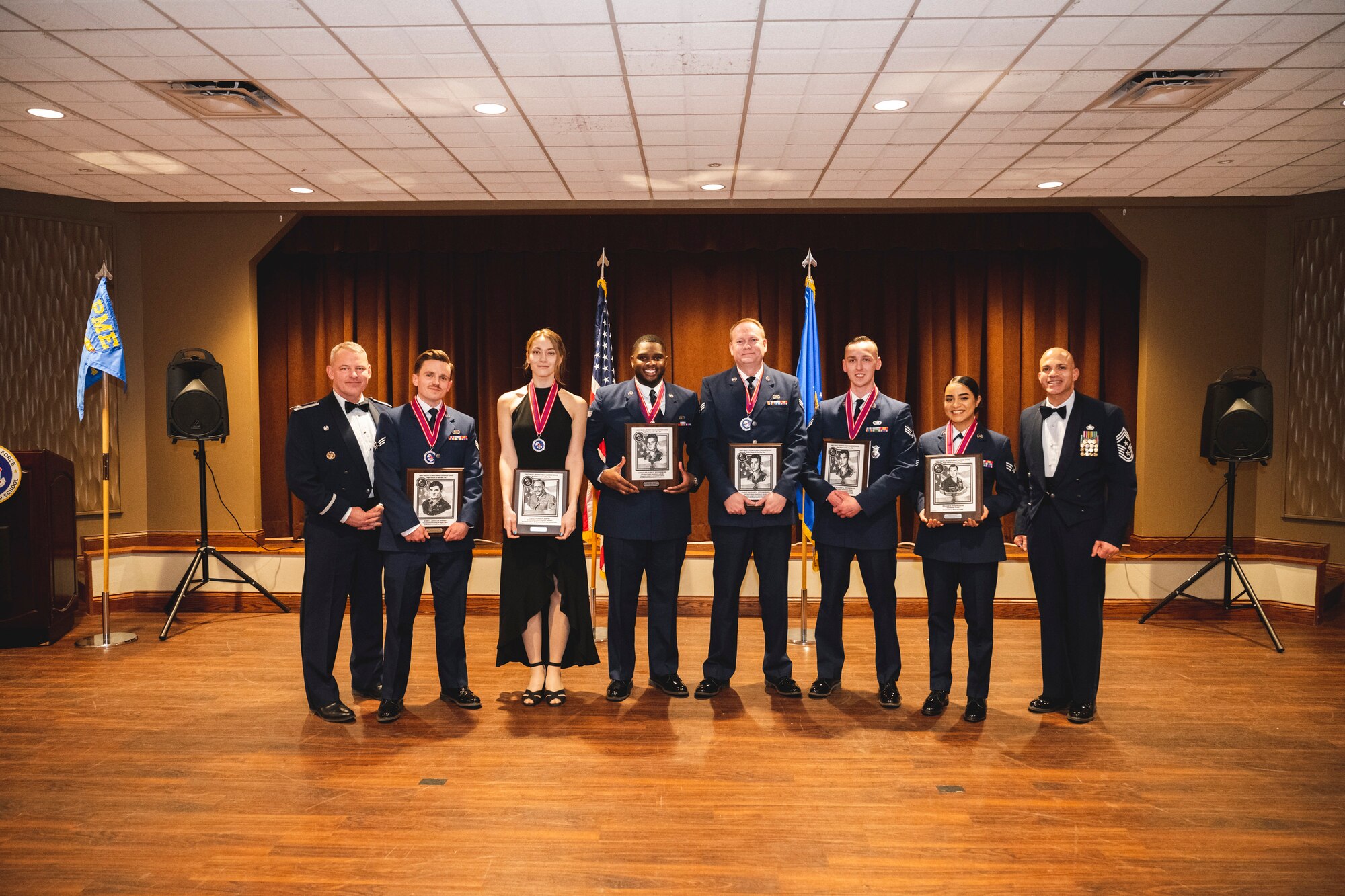 Col. Christopher Meeker, 88th Air Base Wing and installation commander, and Chief Master Sgt. Llyod Morales, 88th Air Base Wing command chief, stand with the honor graduates of Airman Leadership School class 23-B Feb. 9 at the Wright-Patt Club at Wright-Patterson Air Force Base, Ohio.
