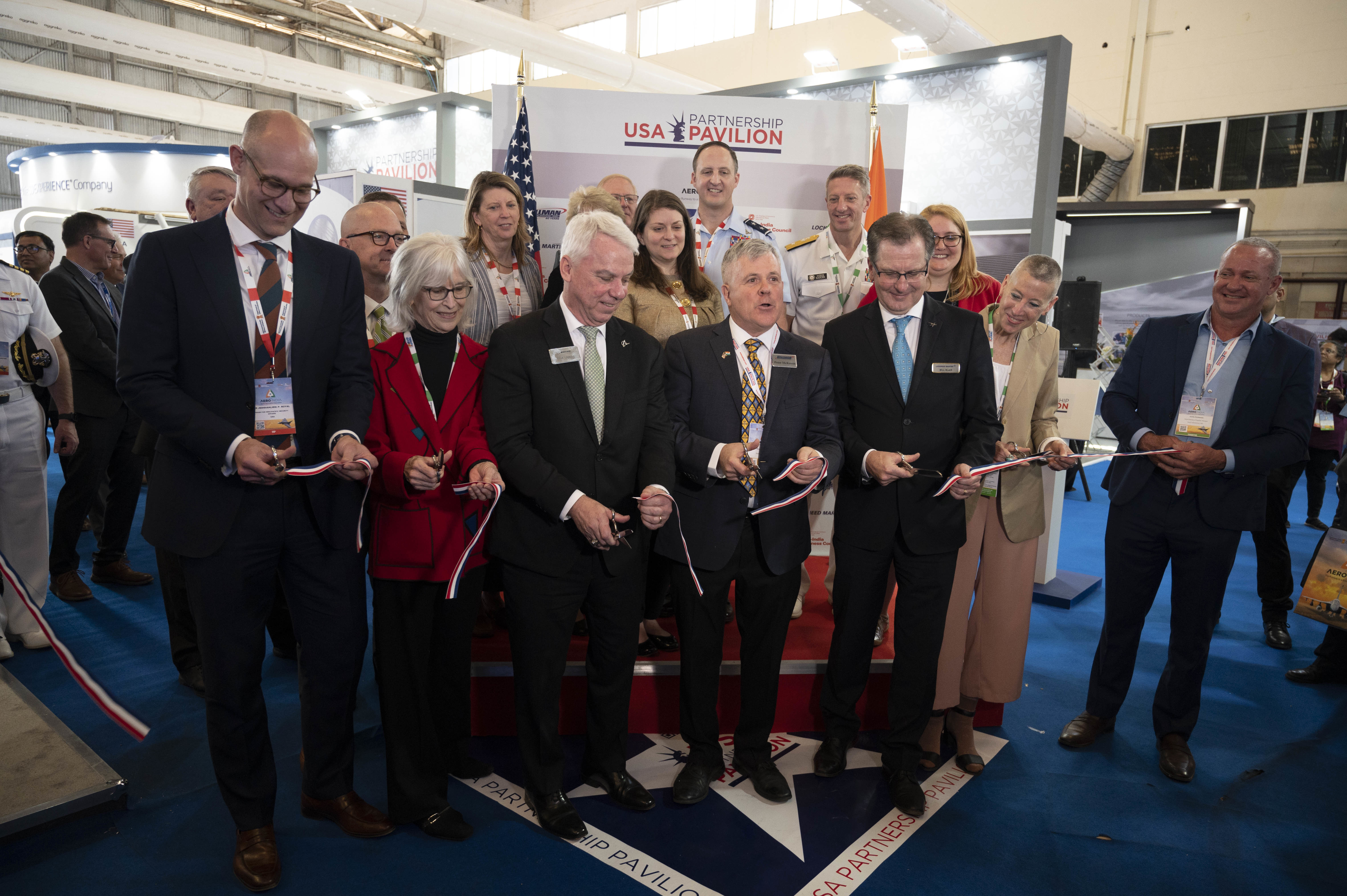 U.S. personnel cut a ribbon at the U.S. Pavilion opening ceremony during Aero India 23 at Yelahanka Air Station, Bengaluru, India on Feb. 13, 2023. The U.S. military’s participation in Aero India is an opportunity for the U.S. to demonstrate combat capabilities to deter adversaries and reassure allies and partners. (U.S. Air Force Photo by Airman 1st Class Emily Saxton)