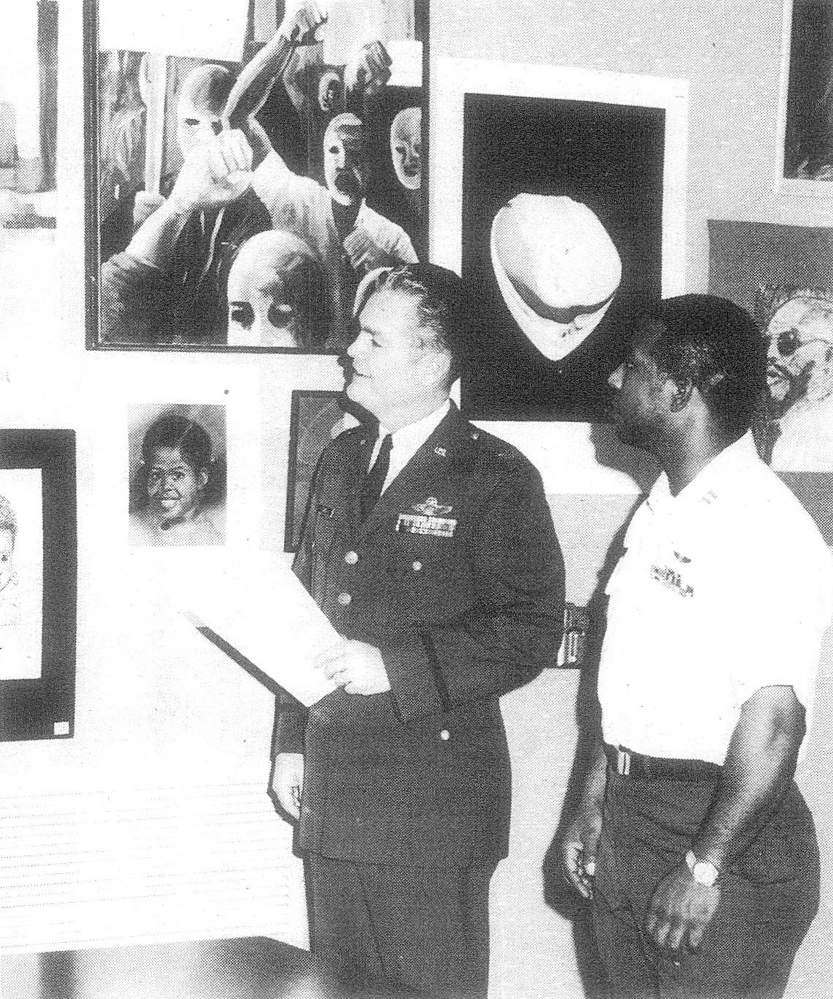 Col H.R. Jewell, 2nd Bomb Wing CV, left, and Capt Maurice Harris, EEO officer, at the Black Art Exhibit displayed at the Barksdale Library during “Black History Week”, Barksdale Air Force Base, La., 1972.