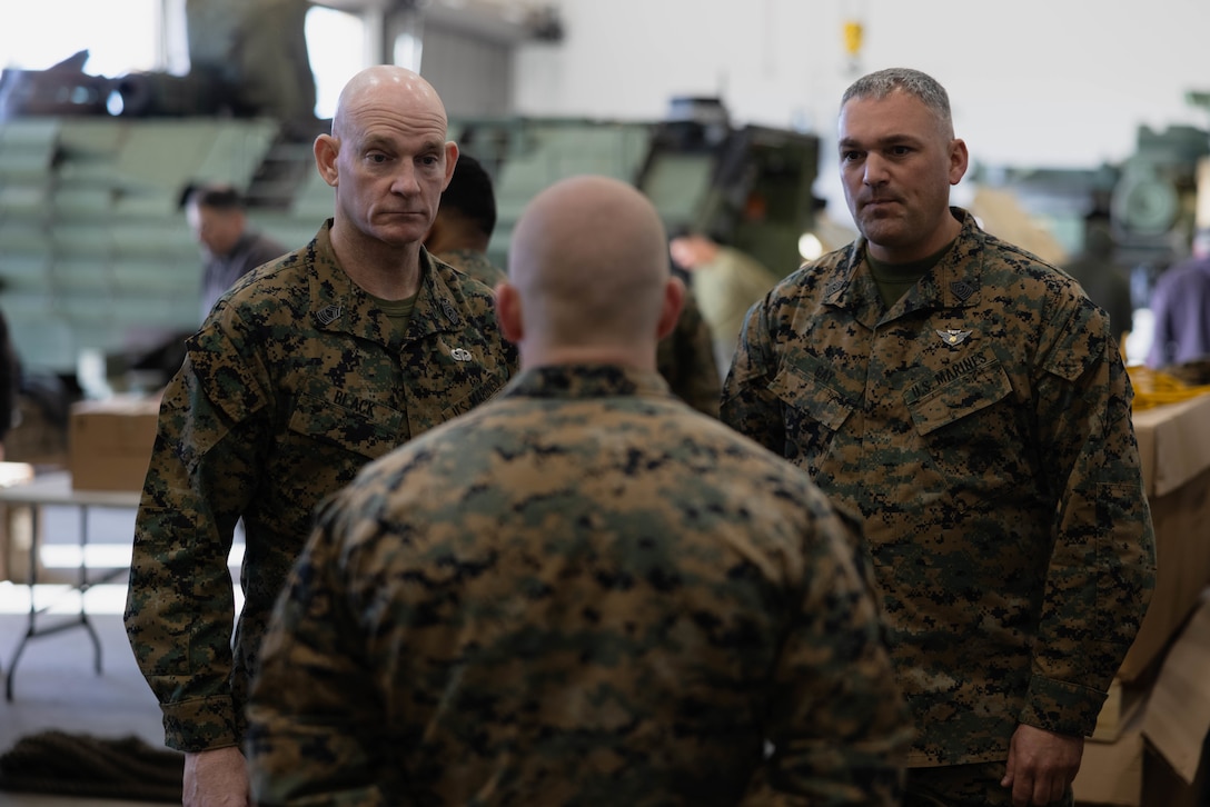 U.S. Marine Sgt. Maj. Troy E. Black, the sergeant major of the Marine Corps, and Sgt. Maj. Adrian Gay, the sergeant major of 3rd Assault Amphibian Battalion, 1st Marine Division, talk with Cpl. Logan Hackworth, an assault amphibious vehicle technician with 3rd AA Bn., on Marine Corps Base Camp Pendleton, California, Feb. 7, 2023. Black’s visit with Camp Pendleton units allows him to advocate for quality of life for the Marines at operational units whose focus is warfighting and training for warfighting. He also spoke with noncommissioned officers regarding the changes associated with Force Design 2030, and the training and education that will prepare them to lead Marines in a fight in the future. (U.S. Marine Corps photo by Lance Cpl. Juan Torres)