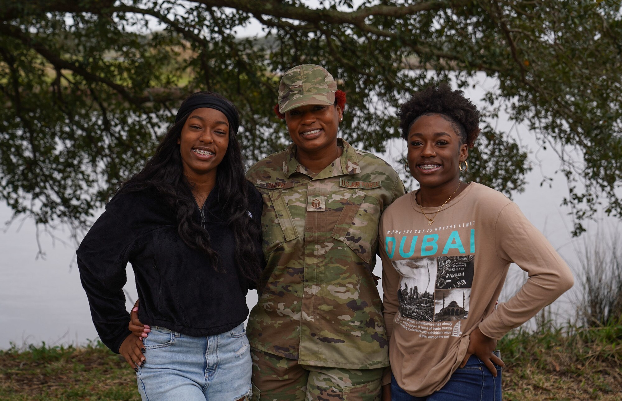 U.S. Air Force Master Sgt. Natasha Smith, 81st Healthcare Operations Squadron internal medicine flight chief, and her daughters, Kaiya and Iyana, pose together at Marina Park on Keesler Air Force Base, Mississippi.