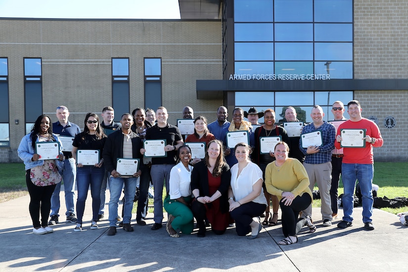 Tifini Steif, Suicide Prevention Program Manager, 85th U.S. Army Reserve Support Command, pauses for a photo with her class during a three-day Ask Care Escort Suicide Intervention tier two training event at Ellington Field Joint Reserve Base in Texas.