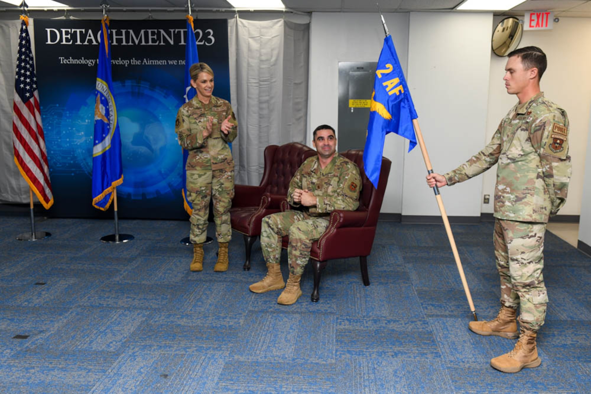U.S. Air Force Maj. Gen. Michele Edmondson, left, Second Air Force commander, and USAF Maj. Jesse Johnson, right, Detachment 23 commander, look at the newly revealed guidon at the Det. 23. Re-alignment ceremony.