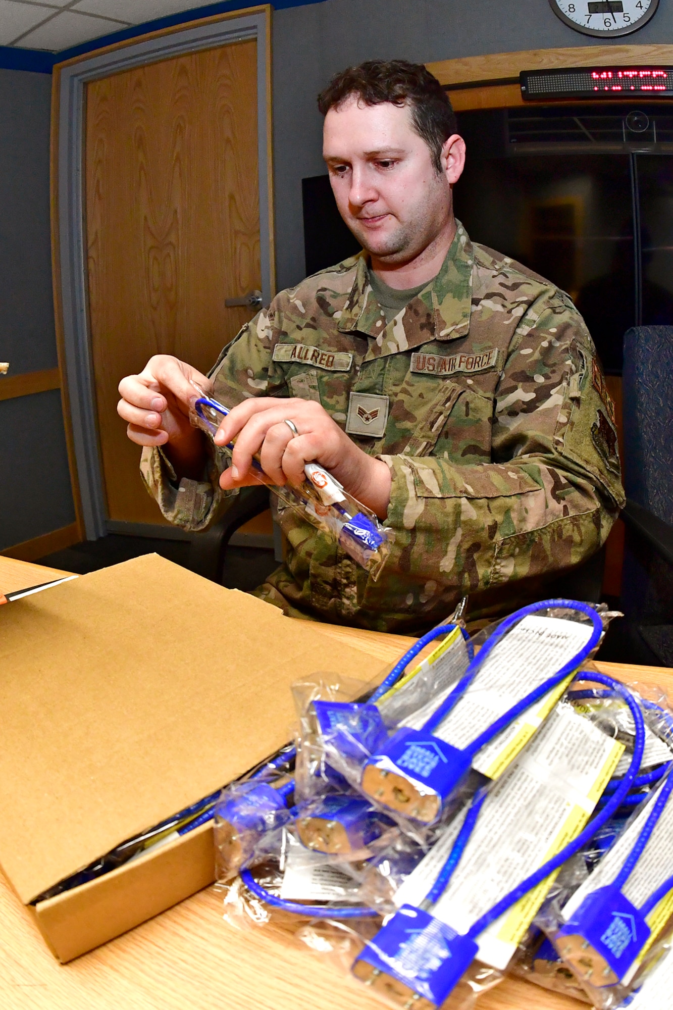 Senior Airman Daniel Allred, 388th Maintenance Squadron, volunteers to prepare suicide prevention cable locks for distribution Feb. 7, 2023, at Hill Air Force Base, Utah. These locks were provided by the Headquarters Air Force Suicide Prevention Program and are known as a time-based prevention tool, designed to delay access to firearms and medicine, for those contemplating suicide during an emotionally charged moment. (U.S. Air Force photo by Todd Cromar)