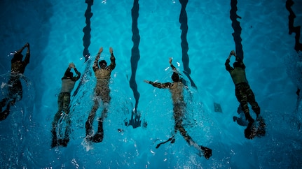 Tactical Air Control Party Airmen competing in Lightning Challenge 2022 swim during a 1,500-meter timed event Nov. 3, 2022 at Joint Base San Antonio-Lackland, Texas.  The competition tested TACP Airmen in agile combat employment, physical fitness and marksmanship. (U.S. Air Force photo by Katherine Spessa/Released)