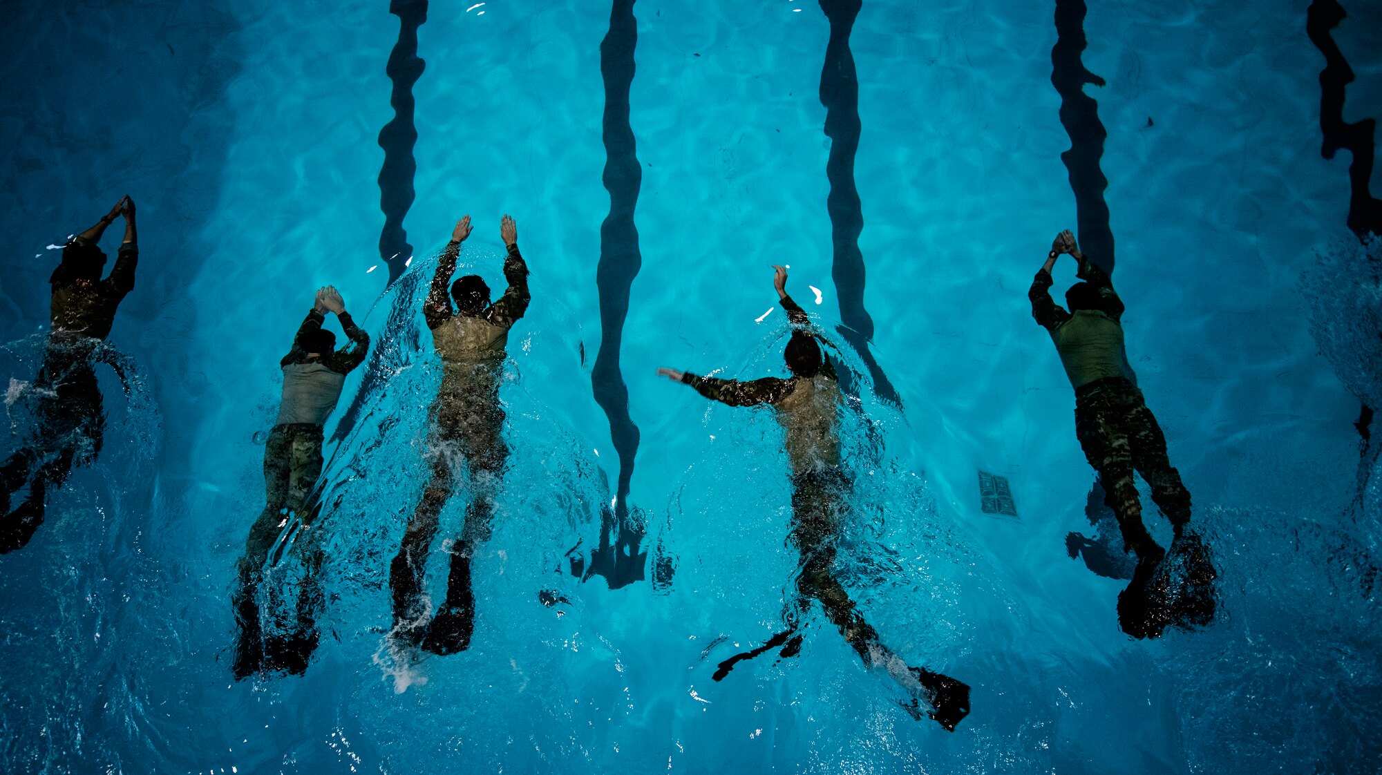 Tactical Air Control Party Airmen competing in Lightning Challenge 2022 swim during a 1,500-meter timed event Nov. 3, 2022 at Joint Base San Antonio-Lackland, Texas.  The competition tested TACP Airmen in agile combat employment, physical fitness and marksmanship. (U.S. Air Force photo by Katherine Spessa/Released)