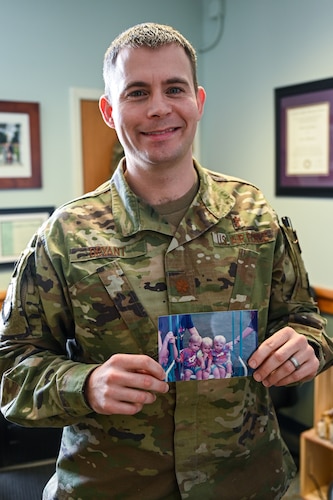 Air Force chaplain holding a family photograph.