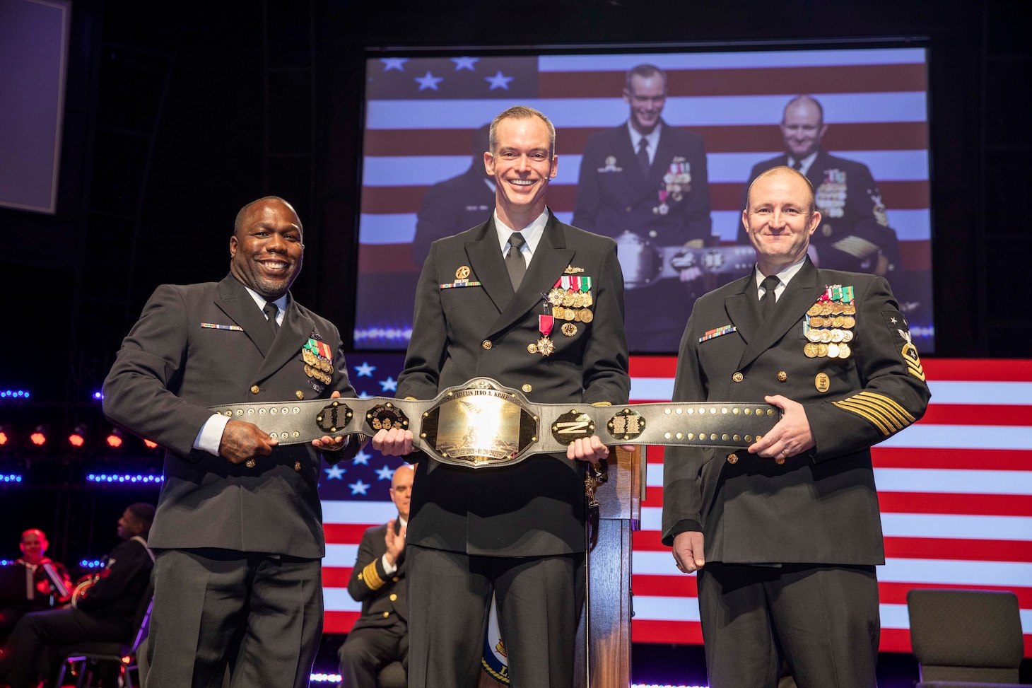 Capt. Judd Krier, former commanding officer of the Wasp-class amphibious assault ship USS Iwo Jima (LHD 7), is presented with a gift from the ship's Chiefs Mess during the ship's change-of-command ceremony. Jan. 20, 2023.