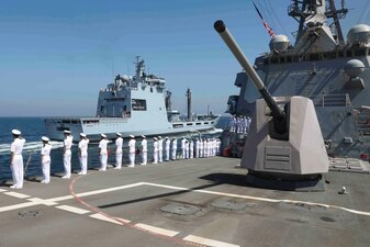 USS Truxtun (DDG 103) salutes the Pakistan navy PNS Moawin (A39) during exercise AMAN 23 in the Arabian Sea.