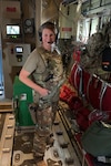 Capt. Connie Anderson, a full-time Guard member assigned to the 139th Aeromedical Squadron, poses for a photo during a flight while deployed to Afghanistan in May 2021.