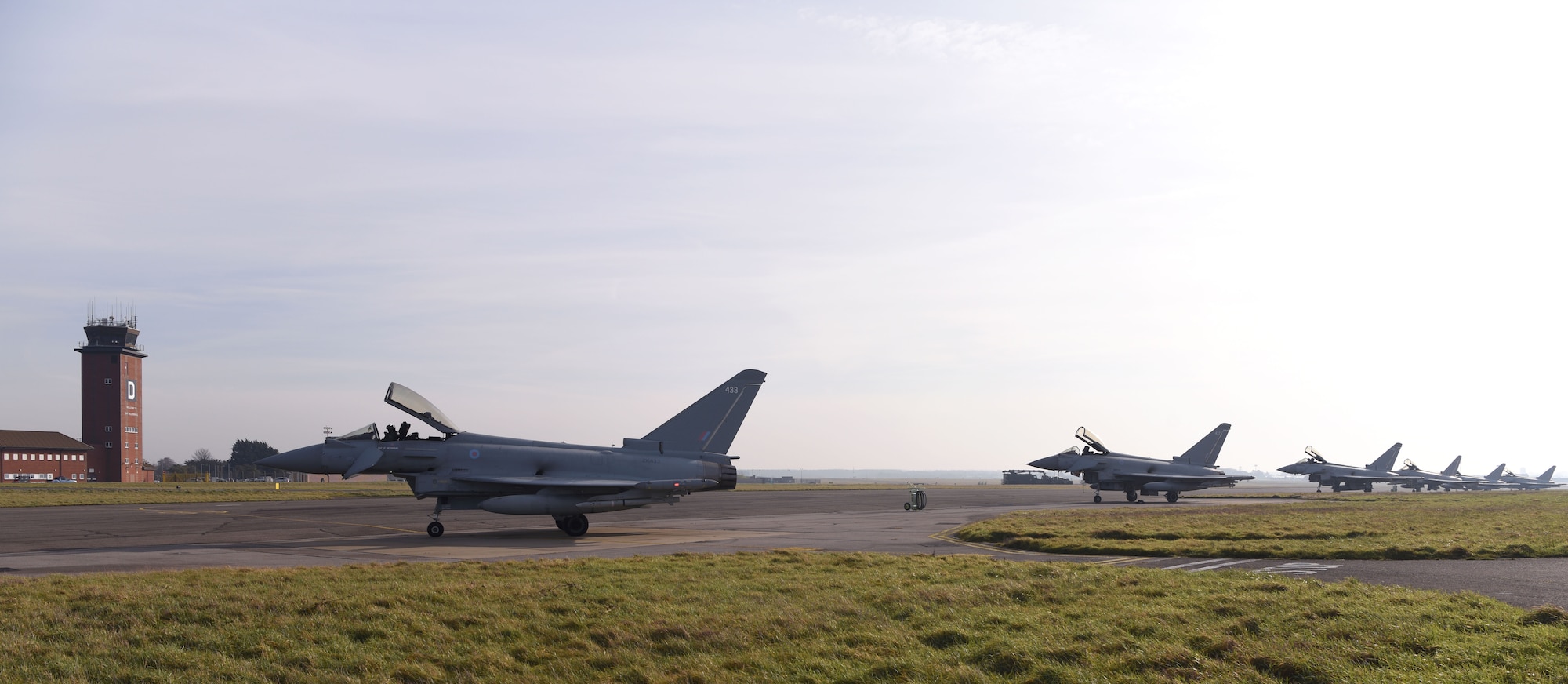 Royal Air Force Eurofighter Typhoons sit on the taxiway at Royal Air Force Mildenhall, England, Feb. 15, 2023. The aircraft, from RAF Coningsby, England, diverted here due to bad weather. The Typhoon is a highly capable and extremely agile multi-role combat aircraft, capable of being deployed for the full spectrum of air operations, including air policing, peace support and high-intensity conflict. (U.S. Air Force photo by Karen Abeyasekere)