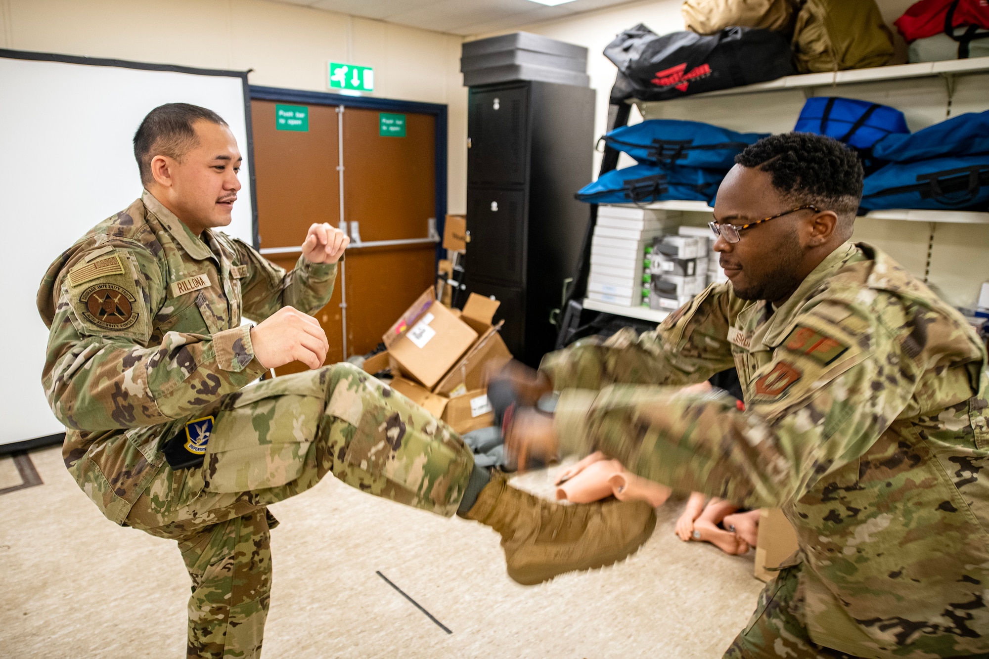An Airman from the 423d Security Forces Squadron, right, demonstrates a baton block during a non-lethal combatives qualification course at RAF Alconbury, England, Feb. 7, 2023. The course provided Defenders with the skills and knowledge to properly detain a suspect using non-lethal combative methods. (U.S. Air Force photo by Staff Sgt. Eugene Oliver)