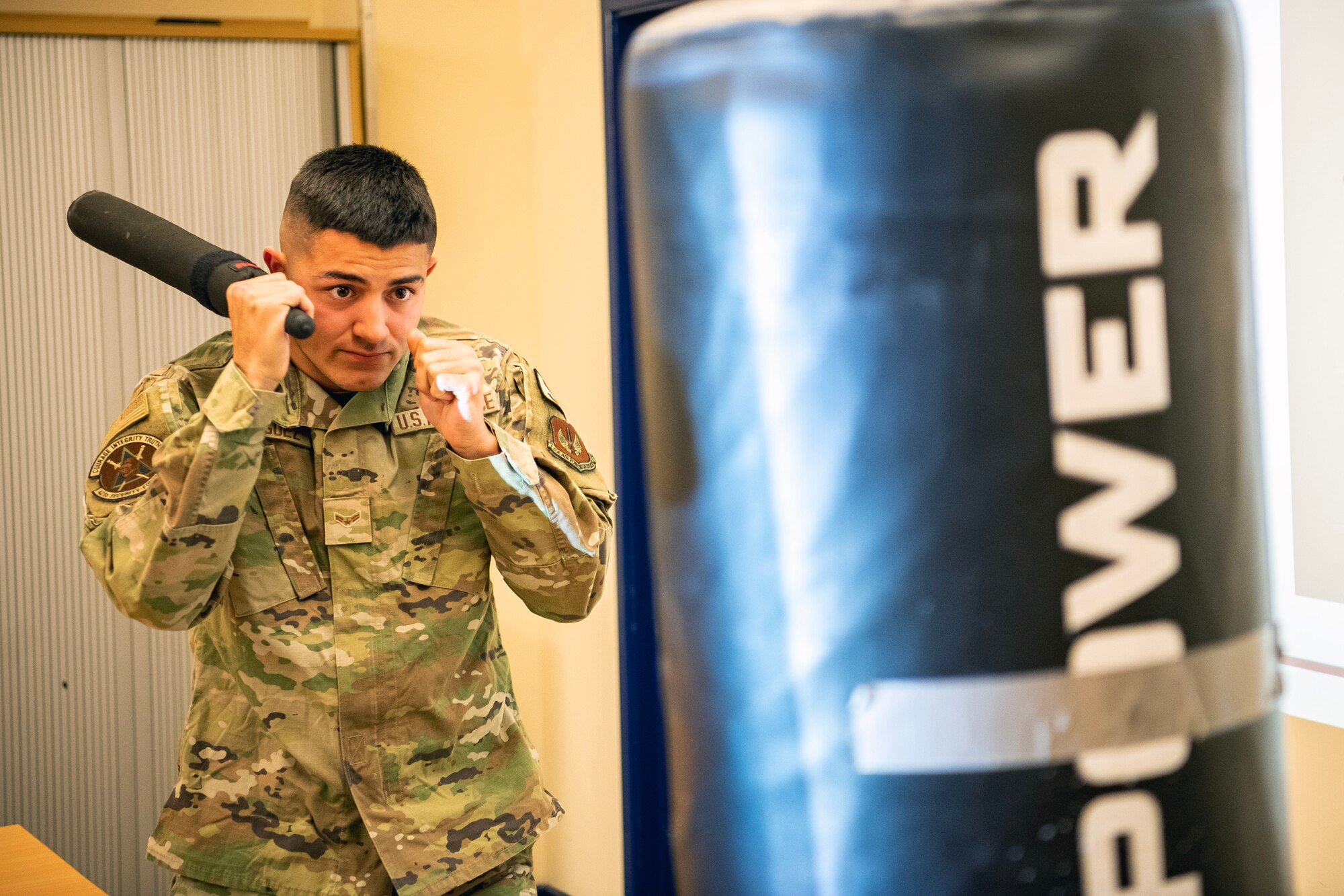 An Airman from the 423d Security Forces Squadron  prepares to demonstrate a baton strike during a non-lethal combatives qualification course at RAF Alconbury, England, Feb. 7, 2023. The course provided Defenders with the skills and knowledge to properly detain a suspect using non-lethal combative methods. (U.S. Air Force photo by Staff Sgt. Eugene Oliver)