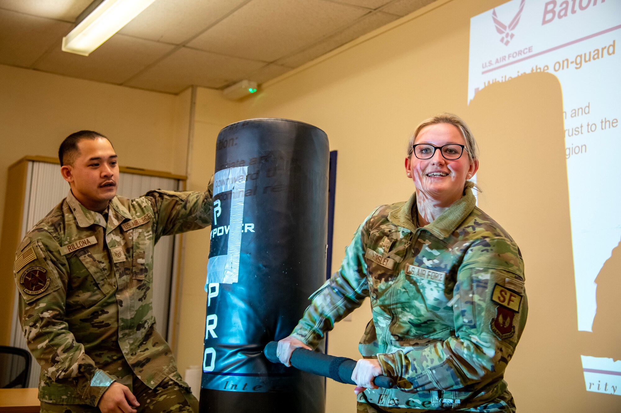 An Airman from the 423d Security Forces Squadron, right, demonstrates a baton strike during a non-lethal combatives qualification course at RAF Alconbury, England, Feb. 7, 2023. The course provided Defenders with the skills and knowledge to properly detain a suspect using non-lethal combative methods. (U.S. Air Force photo by Staff Sgt. Eugene Oliver)