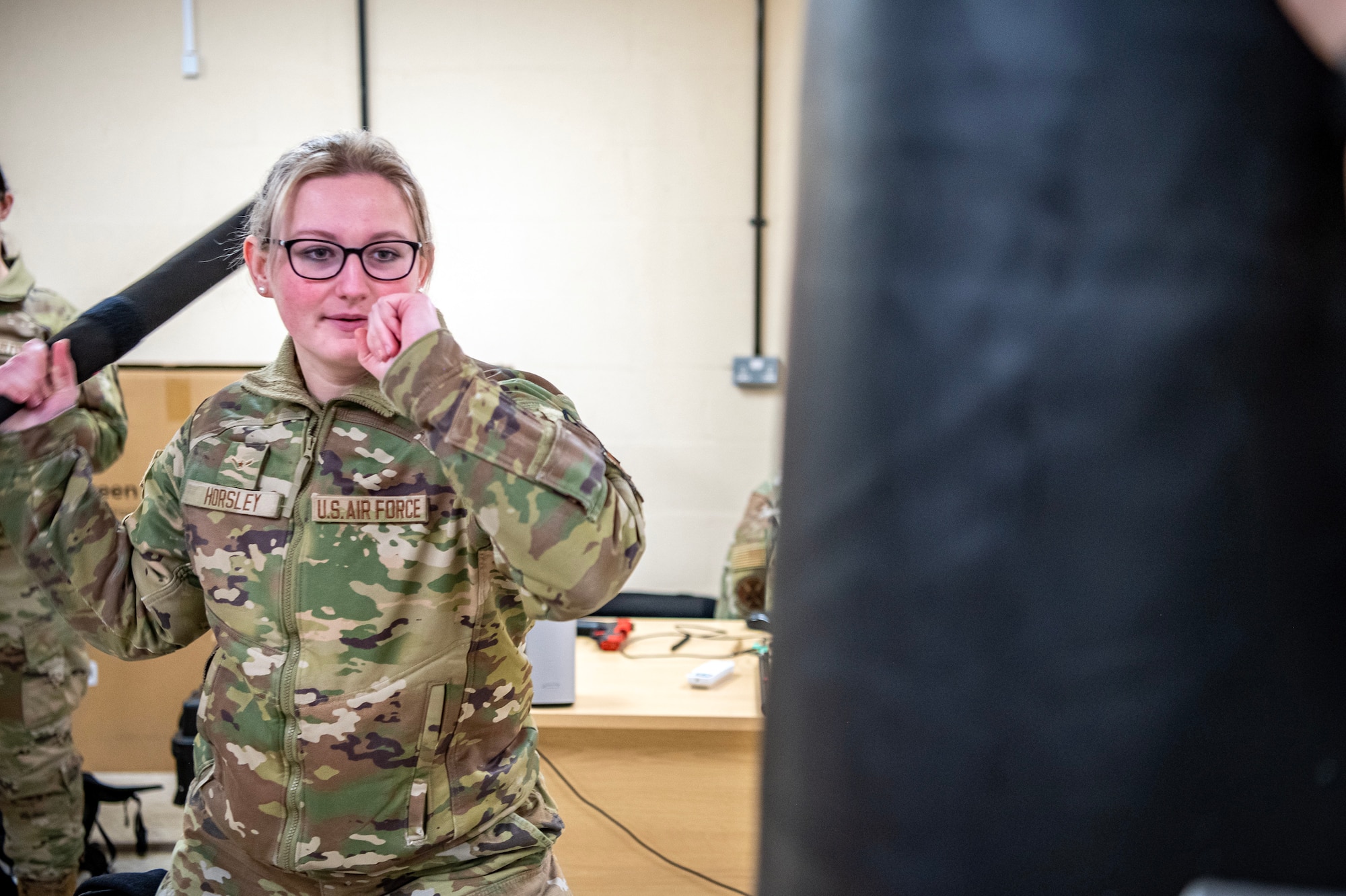 An Airman from the 423d Security Forces Squadron demonstrates a baton strike during a non-lethal combatives qualification course at RAF Alconbury, England, Feb. 7, 2023. The course provided Defenders with the skills and knowledge to properly detain a suspect using non-lethal combative methods. (U.S. Air Force photo by Staff Sgt. Eugene Oliver)