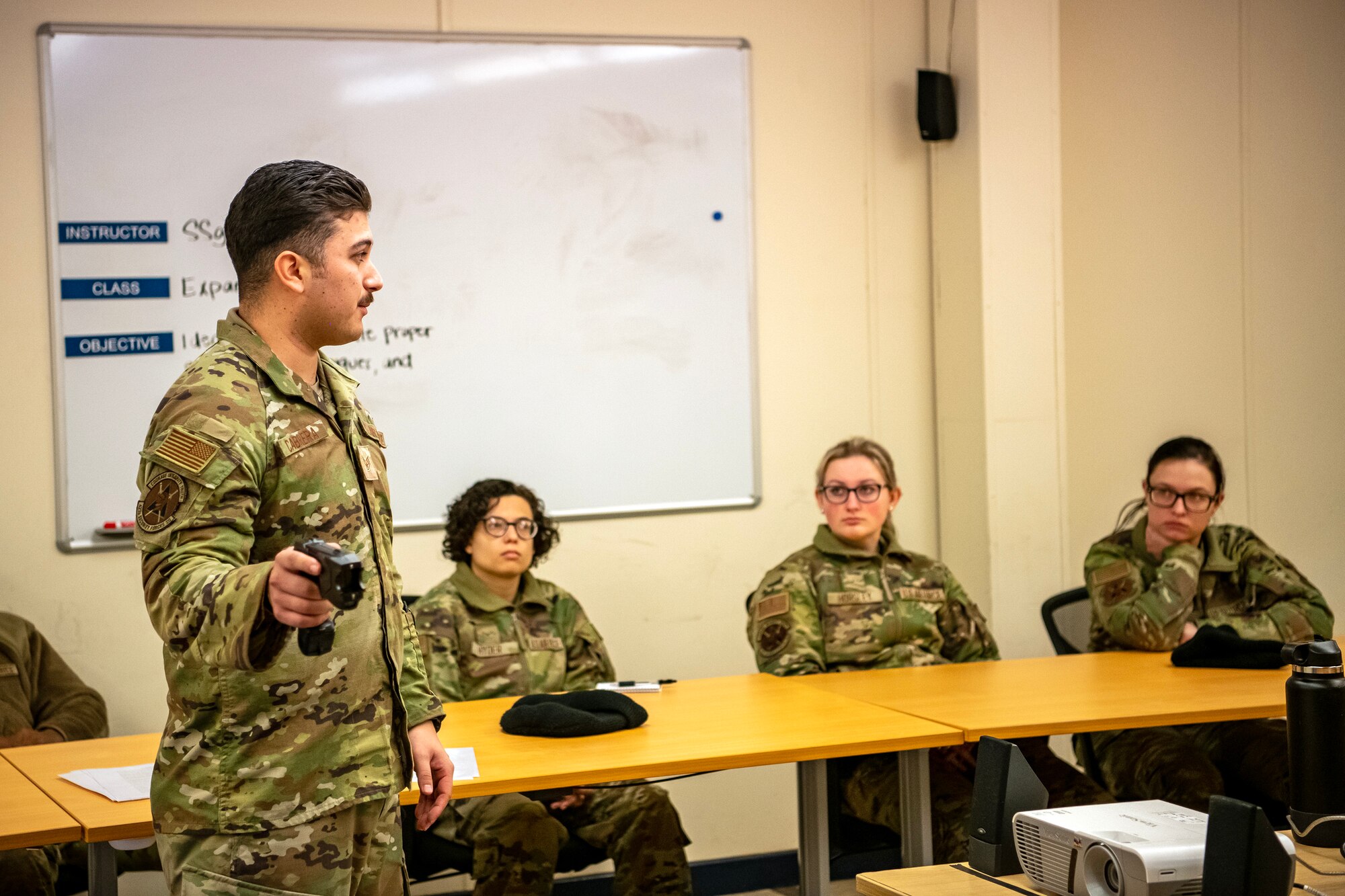 U.S. Air Force Staff Sgt. Andres Carbrera, 423d Security Forces Squadron flight sergeant, provides instruction on proper Taser handling procedures during a non-lethal combatives qualification course at RAF Alconbury, England, Feb. 7, 2023. The course provided Defenders with the skills and knowledge to properly detain a suspect using non-lethal combative methods. (U.S. Air Force photo by Staff Sgt. Eugene Oliver)