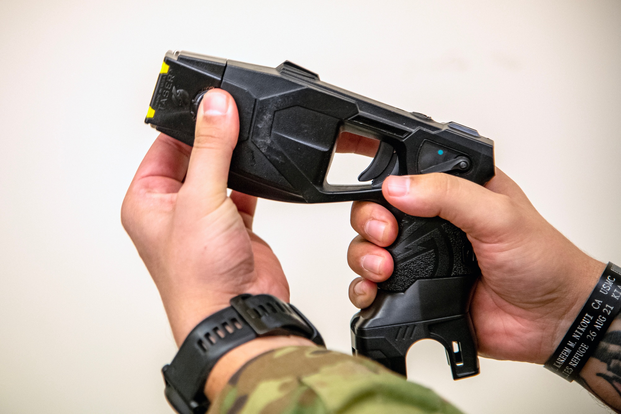 An Airman from the 423d Security Forces Squadron arms a Taser during a non-lethal combatives qualification course at RAF Alconbury, England, Feb. 7, 2023. The course provided Defenders with the skills and knowledge to properly detain a suspect using non-lethal combative methods. (U.S. Air Force photo by Staff Sgt. Eugene Oliver)