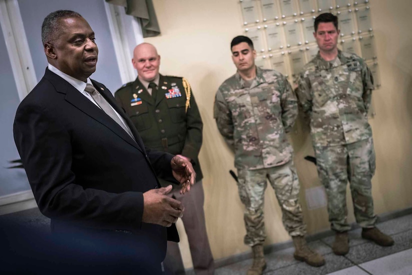 Defense Secretary Lloyd J. Austin III speaks with service members.