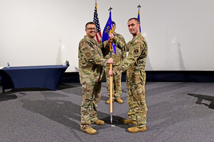 Military members holding guidon