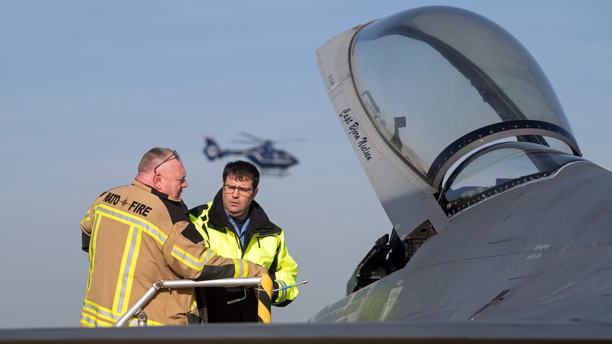 A firefighter receives F-16 training.
