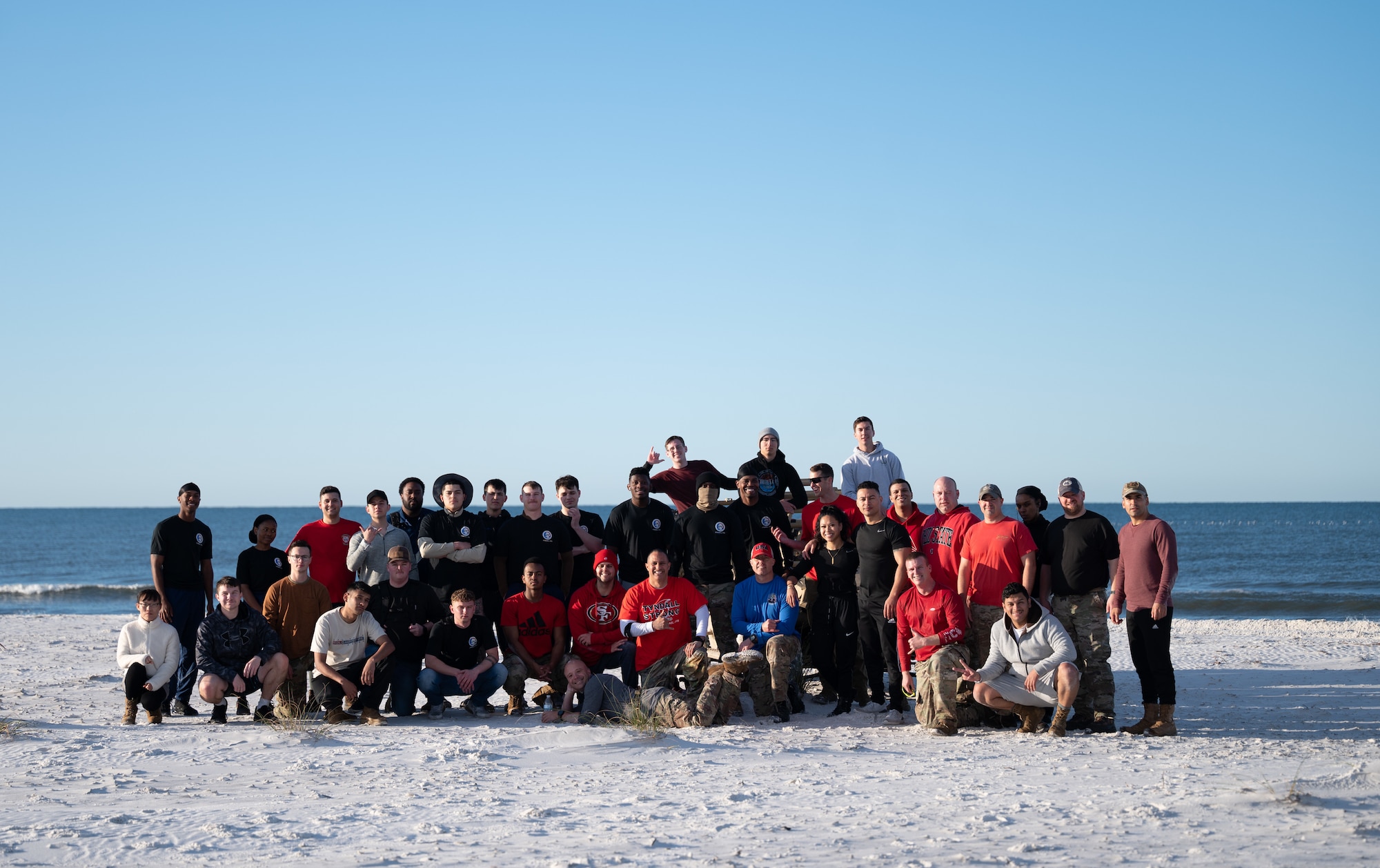 Airmen pose for a group photo on the beach